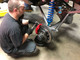 The GenRight tech installing the Alcon brakes